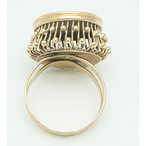 270 - An 18ct gold dress ring, high  set with a 22ct gold Persian coin to the centre, weighs 6.4 grams.