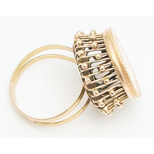 270 - An 18ct gold dress ring, high  set with a 22ct gold Persian coin to the centre, weighs 6.4 grams.