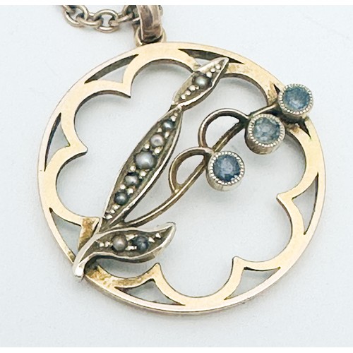 275 - A 9ct gold circular pendant, bezel set with three round faceted blue stones, and eight small graduat... 