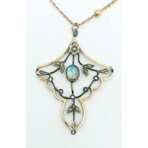 276 - A yellow metal Edwardian style pendant, bezel set with an oval shaped opal to the centre, with vario... 