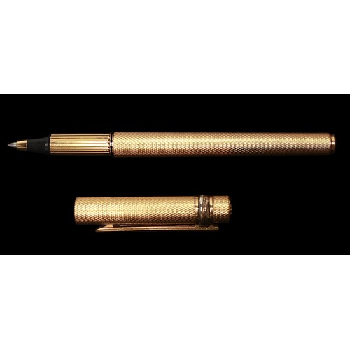 469 - A gold-plated Must de Cartier ballpoint pen, with engine turned decoration to body and cap, numbered... 