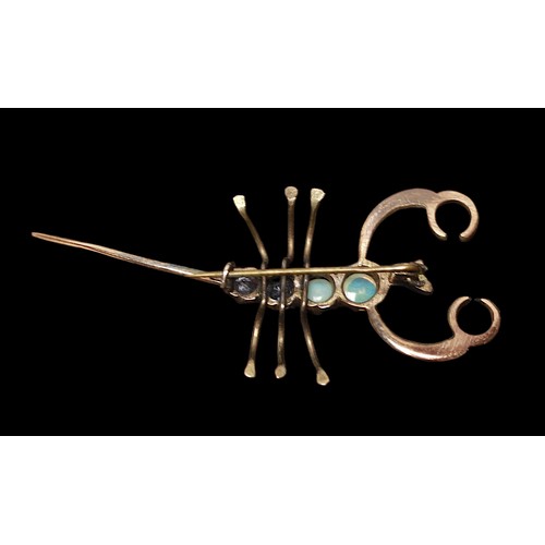 253 - A vintage yellow metal, tests as 9ct or above brooch, modelled as a scorpion, the back set with two ... 