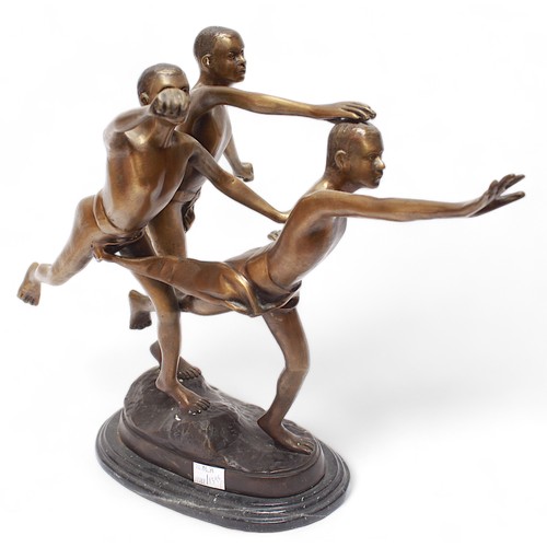 687 - A contemporary bronze sculpture depicting three semi-nude males striking the same pose, upon a natur... 