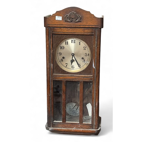 560 - A Victorian black slate and mantel clock, 1920s oak wall clock, and various clock pendulums and a mo... 