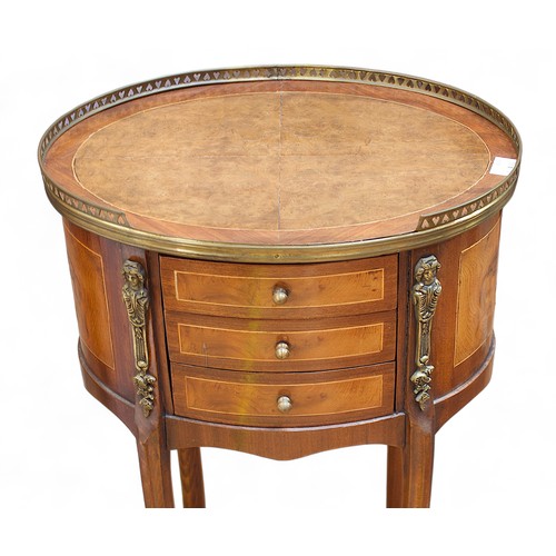 730 - A French walnut oval table, with inlaid top and pierced brass gallery, above a bank of three small d... 