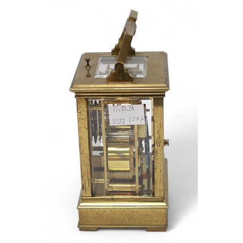 557 - A 19th Century brass carriage clock, with strike repeat button.