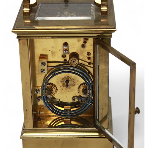 557 - A 19th Century brass carriage clock, with strike repeat button.