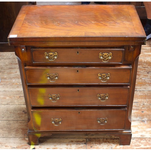 740 - An early 19th century mahogany bachelors chest, with folding swivel top, above a pair of lopers and ... 