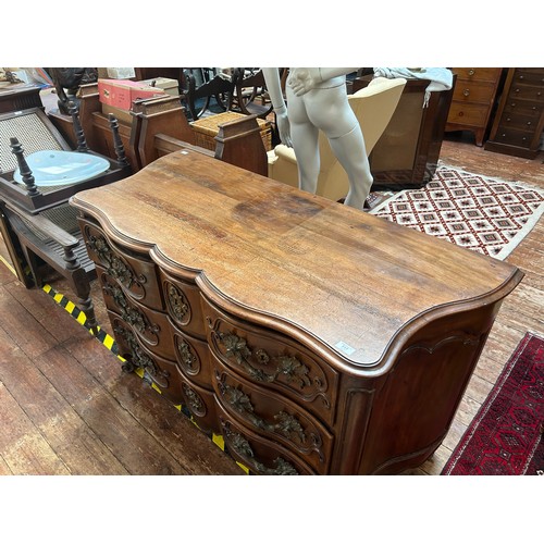 717 - An 18th Century mahogany commode chest of serpentine outline, with foliate gilt bronze mounts and es... 