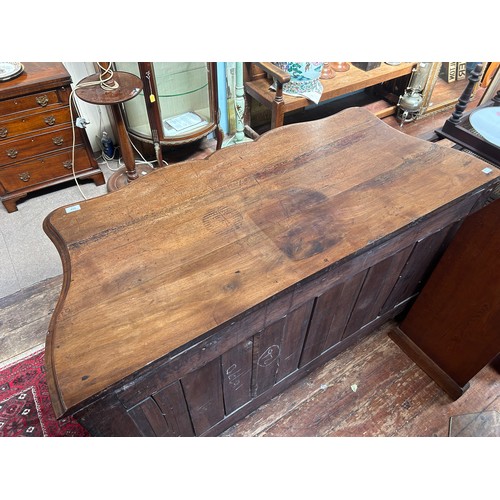 717 - An 18th Century mahogany commode chest of serpentine outline, with foliate gilt bronze mounts and es... 