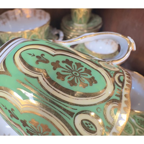 51 - An early 19th Century tea and coffee set, finely gilded on green and yellow grounds, no factory mark... 