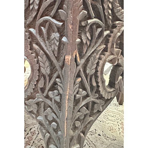 154D - An early 20th Century Indo-Persian carved hardwood and brass-mounted octagonal side table, ornately ... 