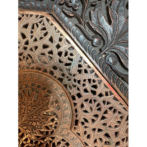 154D - An early 20th Century Indo-Persian carved hardwood and brass-mounted octagonal side table, ornately ... 