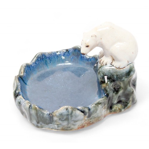 8 - A Royal Doulton Lambeth stoneware soap dish/ashtray, modelled as a polar bear sat on a rock, overloo... 