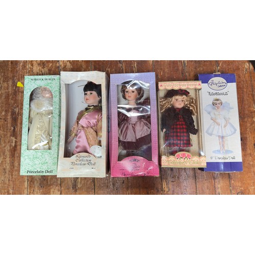 410 - A collection of approximately twenty vintage dolls, predominantly boxed porcelain dolls, comprising ... 