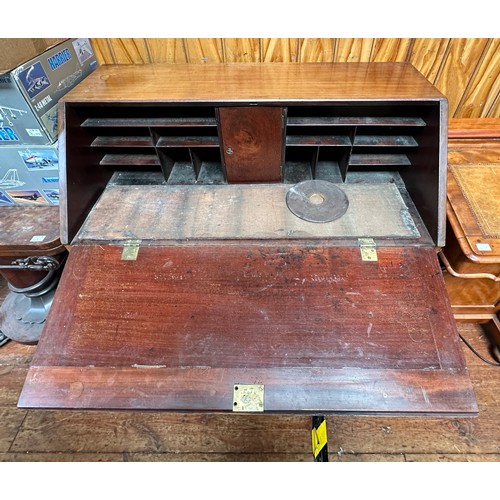 150 - A George III mahogany bureau, with sloped front enclosing pigeonholes, above two short, over three l... 