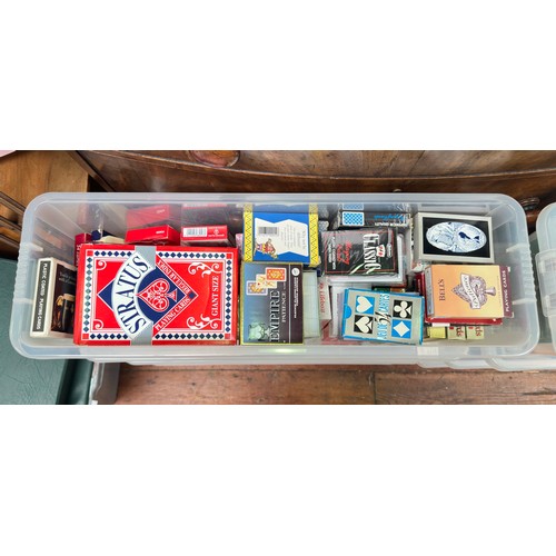 295 - An extensive collection of assorted playing cards across nine plastic boxes, including ‘Bell’s’ play... 