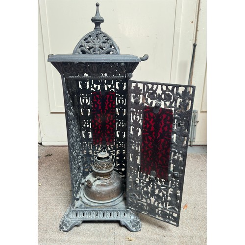 298 - A cast iron reticulated cathedral heater, with removable top, twin handles and raised on pedestal ba... 