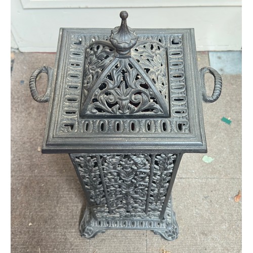 298 - A cast iron reticulated cathedral heater, with removable top, twin handles and raised on pedestal ba... 