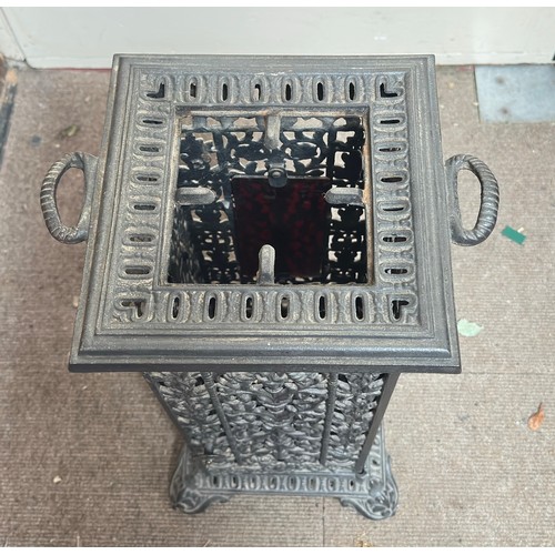 298 - A cast iron reticulated cathedral heater, with removable top, twin handles and raised on pedestal ba... 