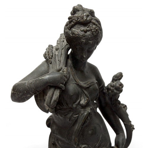 224 - A pair of early 20th century spelter figures modelled as maidens holding a wheatsheaf, items symboli... 