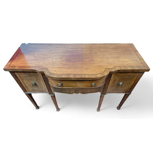 163 - A 19th century mahogany sideboard, the crossbanded top above a central frieze drawer with lions mask... 