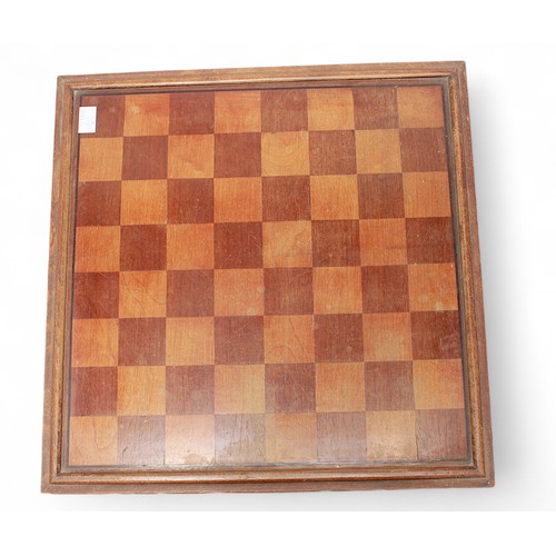 300 - A carved wooden chess board, raised on shaped bracket feet, 47cm diameter, with removable top enclos... 