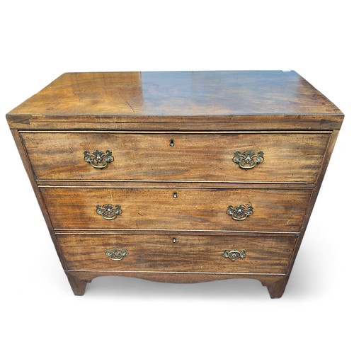 162 - A Georgian mahogany chest of three long, graduated drawers, with later brass handles and flushed bra... 