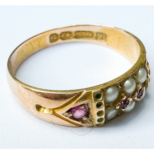 69 - A 15ct yellow gold dress ring, set with seed pearls and rubies, weighs 2.3 grams, hallmarked 1892.