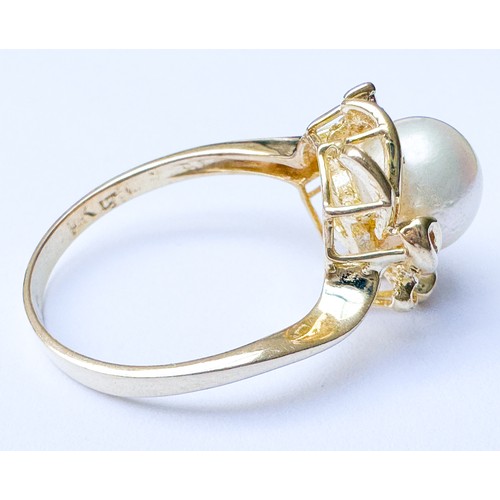 78 - A 14ct yellow gold dress ring, set with a cultured pearl to the centre, and a small diamond offset i... 