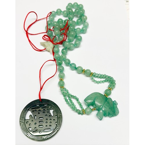 83 - A green jade bead necklace with carved jade lucky elephant, 32 inches in length, together with a gre... 