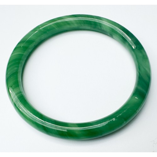 84 - A green jade bangle, weighs grams, measures in diameter, and an icy white jade bangle, weighs grams,... 