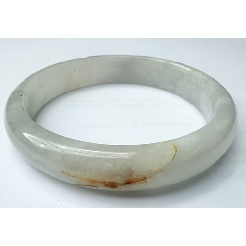 84 - A green jade bangle, weighs grams, measures in diameter, and an icy white jade bangle, weighs grams,... 