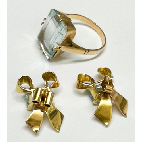 91 - An 18ct yellow gold dress ring, claw set with a oblong-shaped pale faceted aquamarine, measuring mm,... 