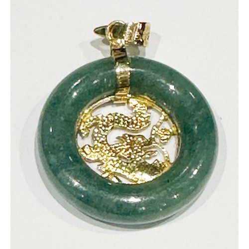 90 - A 14ct yellow gold circular jade pendant, with gold dragon centre, weighs 2.6 grams.