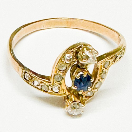 92 - A 9ct yellow gold dress ring, claw set with a round faceted sapphire to the centre and a round old c... 