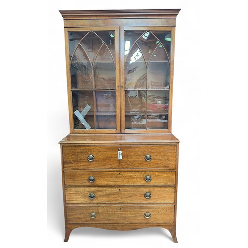 164 - A Regency mahogany secretaire bookcase, the shaped cornice above a pair of glazed doors with Gothic ... 