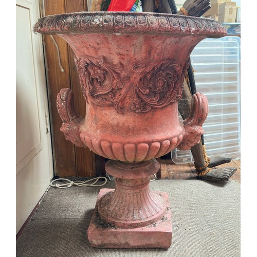 221 - A reconstituted red stone campagna urn, with relief moulded floral and scrolled decoration to sides,... 