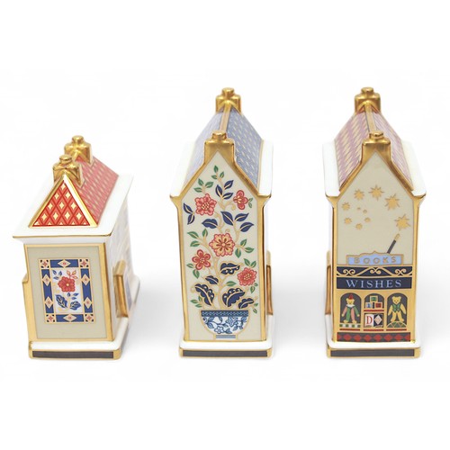 271 - Five assorted Royal Crown Derby paperweights modelled as shops and houses, each with white stopper, ... 