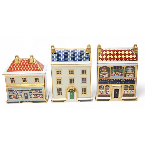 271 - Five assorted Royal Crown Derby paperweights modelled as shops and houses, each with white stopper, ... 