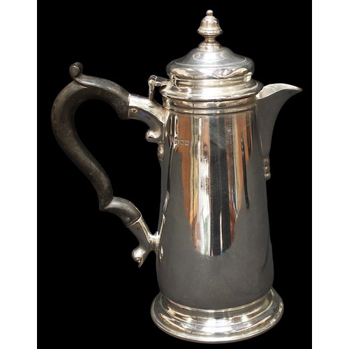 311 - A George V silver hot water jug by C S Harris & Sons Ltd, of tapering cylindrical form, ebonised woo... 