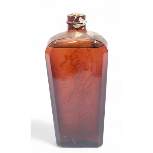 228 - An amber glass bottle of W & A Gilbey Gin, circa 1940s, sealed, cork in tact, coffin shaped bottle e... 