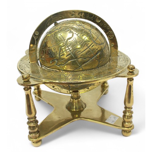 30 - A brass terrestrail table globe with zodiac positions, on quadrapartite stand, 25cm high.