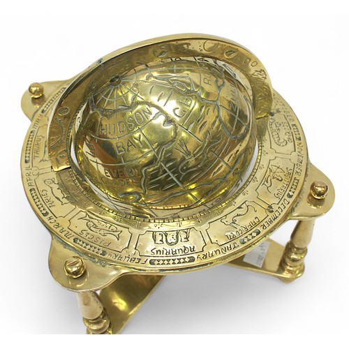 30 - A brass terrestrail table globe with zodiac positions, on quadrapartite stand, 25cm high.