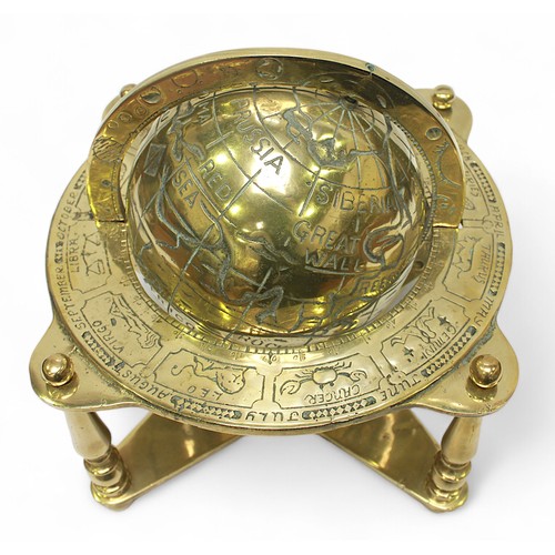 30 - A brass terrestrail table globe with zodiac positions, on quadrapartite stand, 25cm high.