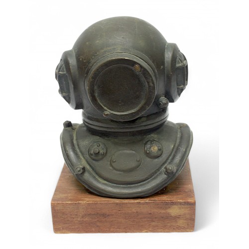 29 - A bronzed composition cast diving helmet on wooden plinth, 16cm high.