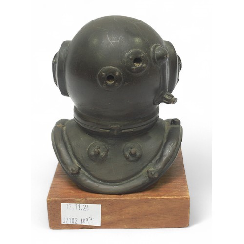 29 - A bronzed composition cast diving helmet on wooden plinth, 16cm high.