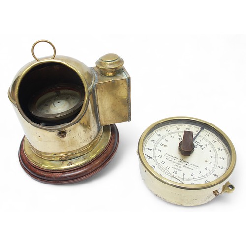 27 - A gimbled marine binacle in brass dome case with open viewing lenticle, mounted on mahogany plinth, ... 