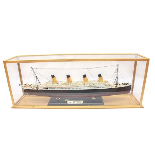 35 - A detailed painted scale model of RMS Titannic, in plexi-glazed wooden case, 29cm x 75cm.