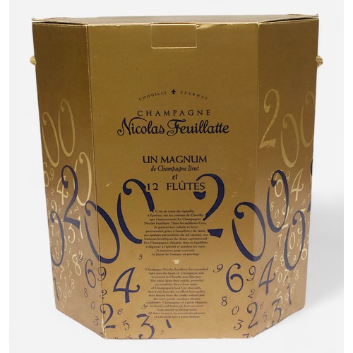 244 - A commemorative Millennium magnum bottle of Nicolas Feuillatte champagne, with a set of 12 flutes, e... 